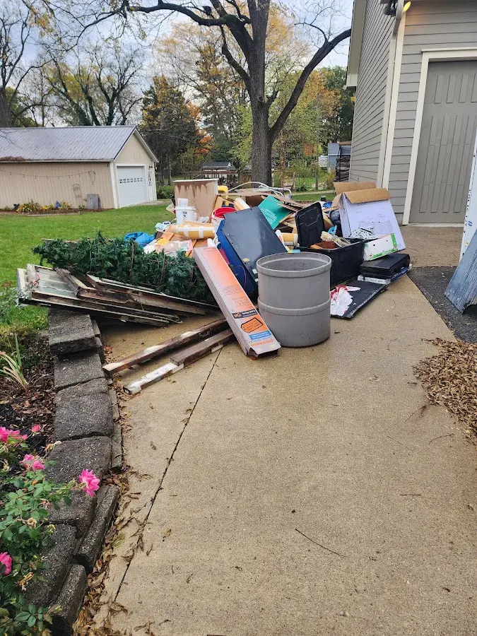Dumpster being loaded with debris for Roofing Dumpster Rental in Roseville